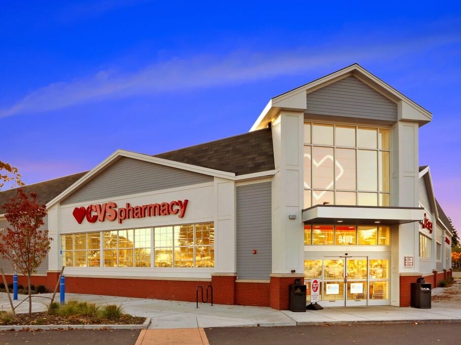 Exterior of a CVS Pharmacy store at twilight with illuminated signage and clear sky, highlighted during an asset appraisal.