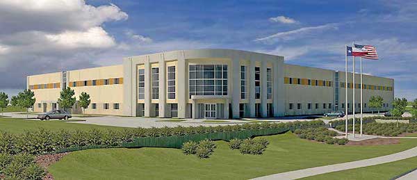 Modern office building with a large American flag on a flagpole, landscaped front lawn, and a clear sky in the background, recently sold to Merit Medical.