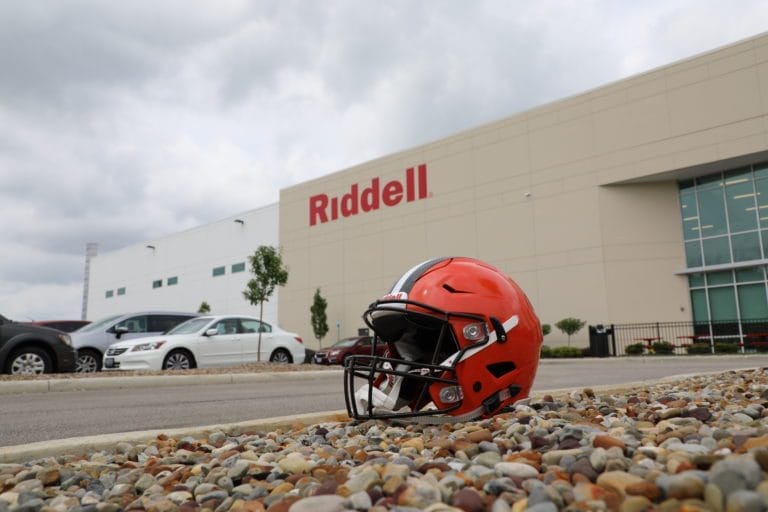 Football helmet in front of the Riddell building